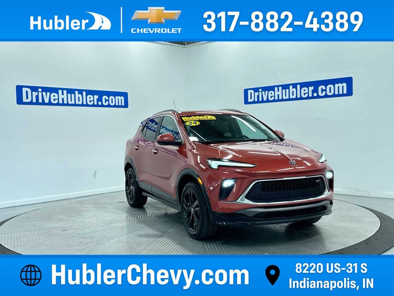 2024 Buick Encore GX Sport Touring in Sunrise Red Metallic — front three-quarter view