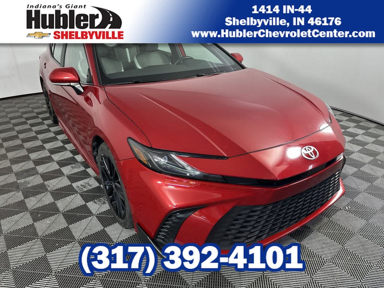 2025 Toyota Camry LE in Red — front three-quarter view