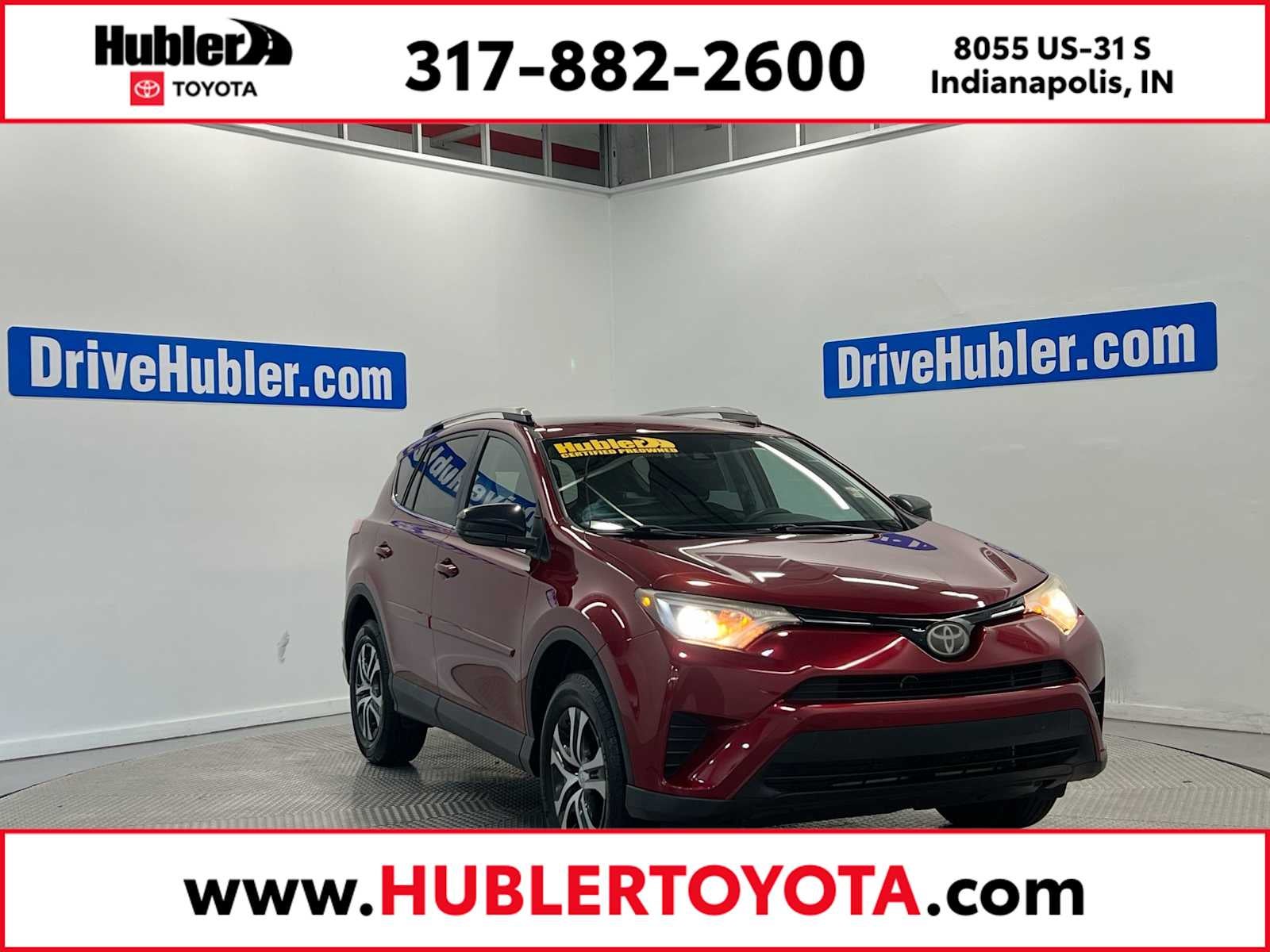 2018 Toyota RAV4 LE in Ruby Flare Pearl — front three-quarter view